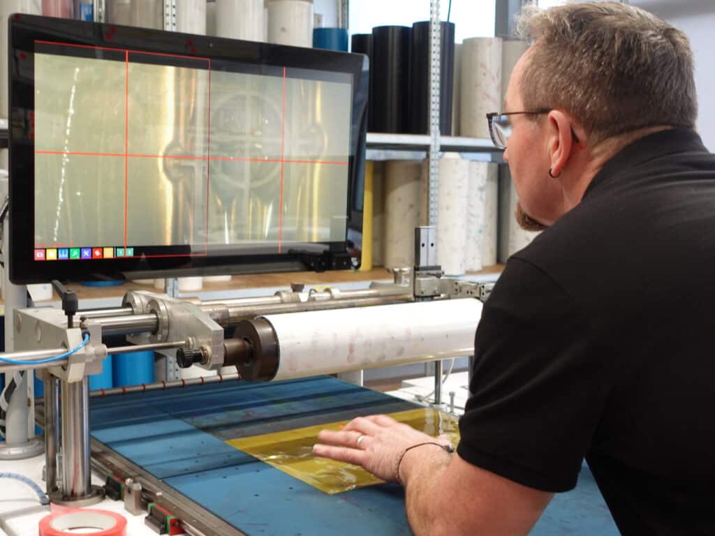 Calibrage de précision par un technicien sur une machine industrielle avec système de visée et caméra d'alignement